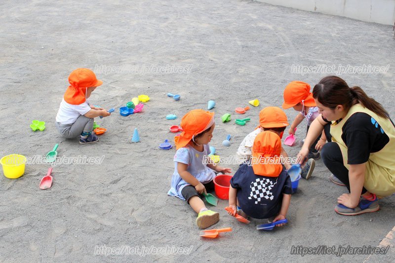 職員と遊ぶ園児たち